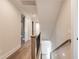 Upstairs hallway with wood floors and white trim at 4009 Yates Mill Pond Rd, Raleigh, NC 27606