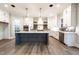 Spacious kitchen boasts an island, modern appliances, and pristine white cabinetry providing ample storage at 4009 Yates Mill Pond Rd, Raleigh, NC 27606