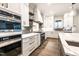 Modern kitchen showcasing stainless steel appliances, double ovens, custom cabinets, and quartz countertops at 4009 Yates Mill Pond Rd, Raleigh, NC 27606