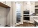 Contemporary kitchen features double ovens, a walk-in pantry, and custom cabinetry offering generous storage space at 4009 Yates Mill Pond Rd, Raleigh, NC 27606