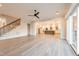 Open concept living room and kitchen with a ceiling fan and hardwood floors at 4009 Yates Mill Pond Rd, Raleigh, NC 27606