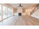 Open-concept living room features hardwood floors, large windows, and a fireplace with custom built-ins at 4009 Yates Mill Pond Rd, Raleigh, NC 27606