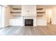 Living room featuring fireplace with built-in shelving and cabinets at 4009 Yates Mill Pond Rd, Raleigh, NC 27606