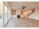 Spacious living room with hardwood floors, fireplace, and access to deck at 4009 Yates Mill Pond Rd, Raleigh, NC 27606