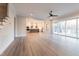 Bright open concept living room and kitchen with a ceiling fan and hardwood floors at 4009 Yates Mill Pond Rd, Raleigh, NC 27606