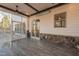 Cozy screened porch with stone accents, ceiling fan, and wood-look tile flooring at 4009 Yates Mill Pond Rd, Raleigh, NC 27606