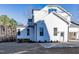 Bright white house with multiple windows, a walkout, and a side-entry parking pad at 4009 Yates Mill Pond Rd, Raleigh, NC 27606