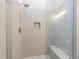 Walk-in shower featuring a frameless glass door, shower seat, niche, rain style shower head, and mosaic floor at 4009 Yates Mill Pond Rd, Raleigh, NC 27606