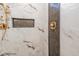 Close-up of shower featuring marble tile and bronze shower head at 4009 Yates Mill Pond Rd, Raleigh, NC 27606