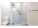Modern shower with frameless glass, niche, mosaic tile floor, and contrasting black hardware at 4009 Yates Mill Pond Rd, Raleigh, NC 27606