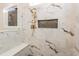 Shower with marble tile, gold fixtures, and built-in bench and shelf at 4009 Yates Mill Pond Rd, Raleigh, NC 27606