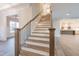 Elegant staircase featuring hardwood steps, black iron railings and recessed lighting at 4009 Yates Mill Pond Rd, Raleigh, NC 27606