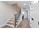 Elegant staircase with wood treads, black iron railings, and natural light at 4009 Yates Mill Pond Rd, Raleigh, NC 27606