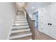 Stylish staircase with wood and white finish, accented by black iron railings at 4009 Yates Mill Pond Rd, Raleigh, NC 27606
