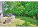 Lush backyard with mature trees and a generator, perfect for outdoor activities and relaxation at 4114 Sudbury Rd, Durham, NC 27704