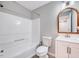 Bathroom with a tub and shower combination and a wood-framed mirror at 4114 Sudbury Rd, Durham, NC 27704