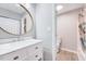 Updated bathroom with a sleek vanity, round mirror, and coordinated shower curtain at 4114 Sudbury Rd, Durham, NC 27704