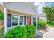 Eye-catching single-Gathering home with a bright red door, tidy landscaping, and a covered porch at 4114 Sudbury Rd, Durham, NC 27704