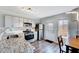 Well-lit kitchen with stainless steel appliances, granite counters, and an adjacent dining area at 4114 Sudbury Rd, Durham, NC 27704