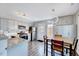 Modern kitchen and dining area with stainless steel appliances, granite countertops, and stylish lighting at 4114 Sudbury Rd, Durham, NC 27704