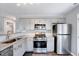 Updated kitchen featuring stainless steel appliances, granite countertops and grey cabinets at 4114 Sudbury Rd, Durham, NC 27704