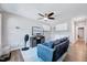 Bright living room featuring a ceiling fan, comfortable sofa, and a modern entertainment setup at 4114 Sudbury Rd, Durham, NC 27704