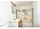 Bathroom with tiled walls, sink vanity, mirror, window, and a bathtub at 420 Peyton St, Raleigh, NC 27610
