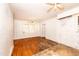 Spacious bedroom offers hardwood floors, wood paneling, a ceiling fan, and a window at 420 Peyton St, Raleigh, NC 27610