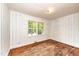 Inviting bedroom showcases hardwood floors, wood-paneled walls, and a window with a view at 420 Peyton St, Raleigh, NC 27610