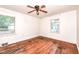 Charming bedroom features hardwood floors, two windows, and a ceiling fan for comfort at 420 Peyton St, Raleigh, NC 27610