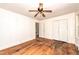 Relaxing bedroom with hardwood floors, ceiling fan, closet, and natural light from a window at 420 Peyton St, Raleigh, NC 27610