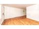 Bright living room featuring hardwood floors, wood-paneled walls, and natural light from a window at 420 Peyton St, Raleigh, NC 27610