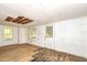 A sun room with white painted walls and ceiling needing some repairs, including windows and a back door at 420 Peyton St, Raleigh, NC 27610