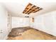 A sun room with white painted brick walls and needing some repairs to the ceiling, with access to the back yard at 420 Peyton St, Raleigh, NC 27610