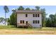 Exterior view of a house with a wooden deck overlooking a spacious backyard, complemented by large windows at 452 Golden Dragonfly St, Wake Forest, NC 27587