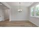 Inviting dining room featuring a stylish chandelier, ample natural light, and hardwood floors, perfect for gatherings at 452 Golden Dragonfly St, Wake Forest, NC 27587
