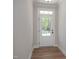 Bright entryway featuring a stylish white door with a transom window and contemporary wood flooring at 452 Golden Dragonfly St, Wake Forest, NC 27587