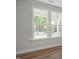 Bright room featuring large windows with natural light, highlighting stylish trim and modern flooring at 452 Golden Dragonfly St, Wake Forest, NC 27587