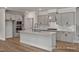Modern kitchen with stainless appliances, gray cabinets, white countertops, and center island at 452 Golden Dragonfly St, Wake Forest, NC 27587
