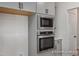 Close up of stainless steel oven and microwave in a modern, neutral colored kitchen at 452 Golden Dragonfly St, Wake Forest, NC 27587