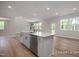 Open concept kitchen with hardwood floors, modern island, and a stainless steel dishwasher at 452 Golden Dragonfly St, Wake Forest, NC 27587