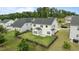 Aerial view of a home with a fenced backyard, showing a patio and lush green lawn at 4718 Sleepy Falls Run, Knightdale, NC 27545