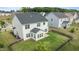Aerial view showcasing a spacious fenced backyard with green lawn, enhanced by a sunroom and patio area at 4718 Sleepy Falls Run, Knightdale, NC 27545