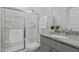 Bathroom featuring a shower with glass doors, granite countertop, grey cabinets, a sink and a toilet at 4718 Sleepy Falls Run, Knightdale, NC 27545