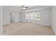 Spacious bedroom with plush carpeting, white walls, large windows, and a ceiling fan at 4718 Sleepy Falls Run, Knightdale, NC 27545