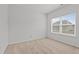 A bright bedroom with carpet flooring and a window with a view of the outdoors at 4718 Sleepy Falls Run, Knightdale, NC 27545