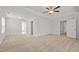 Open bedroom layout featuring carpet flooring, white walls, recessed lighting, and several doors to other rooms at 4718 Sleepy Falls Run, Knightdale, NC 27545