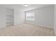 Bedroom featuring neutral carpet, a window, and built-in shelves at 4718 Sleepy Falls Run, Knightdale, NC 27545
