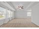 Large carpeted bedroom with neutral walls, lots of windows for natural light and a ceiling fan at 4718 Sleepy Falls Run, Knightdale, NC 27545