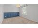 Bedroom featuring modern wainscotting and a neutral color carpet at 4718 Sleepy Falls Run, Knightdale, NC 27545